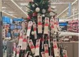 An angel tree tagged with children’s wishlists at a local Walmart.
