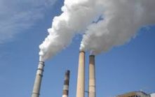 Smoke stacks with steam rising out