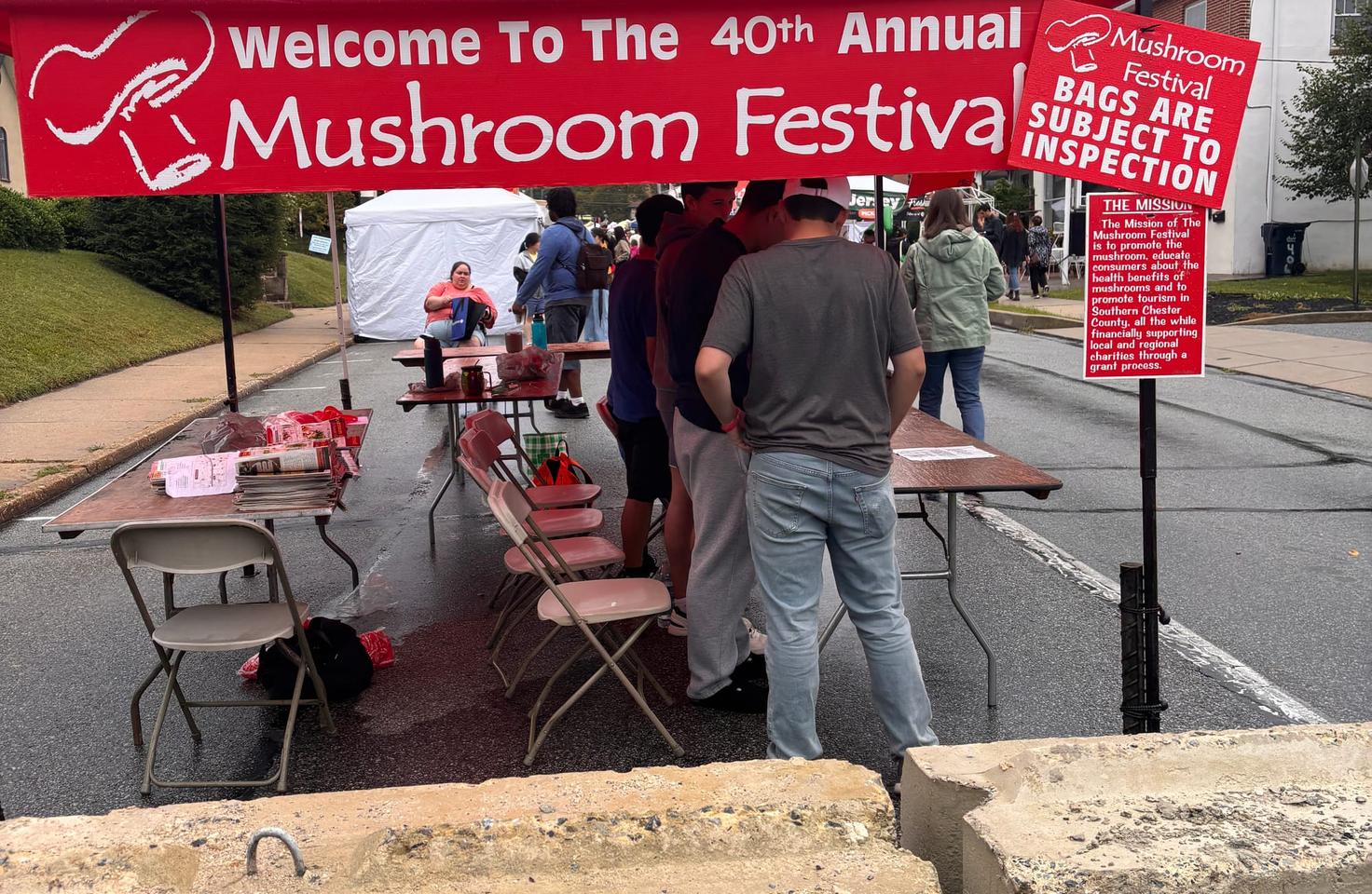 The Mushroom Festival welcome stand handing out stickers, pamphlets, and information about the festivities.