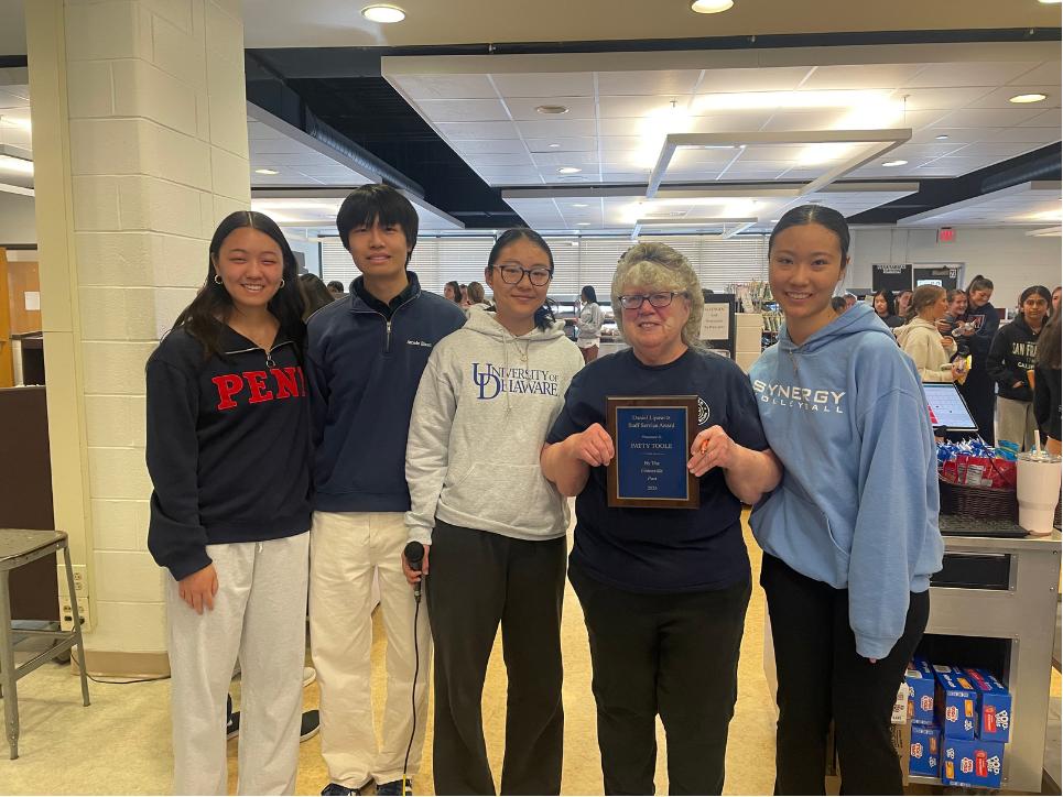Ms. Patty Toole poses with her award